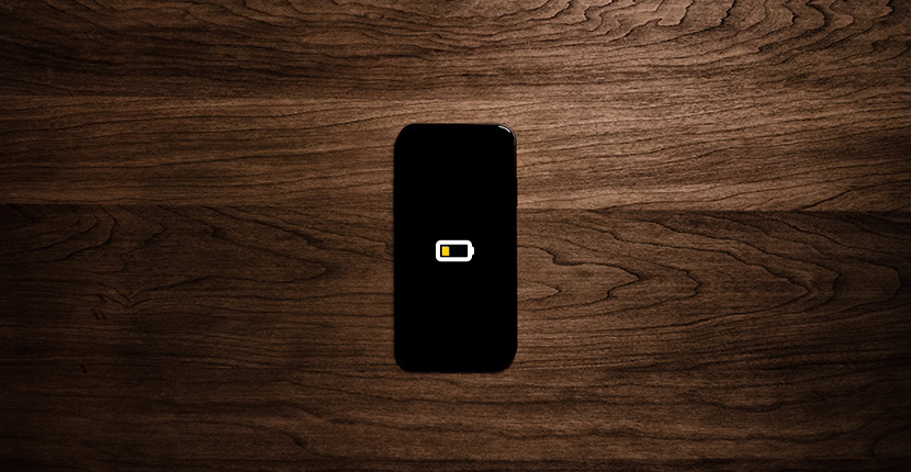 a phone with low battery sitting on a table