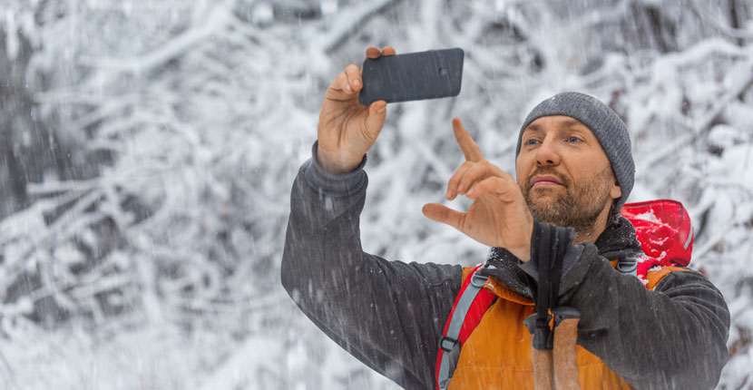 Guy taking photos in the snow