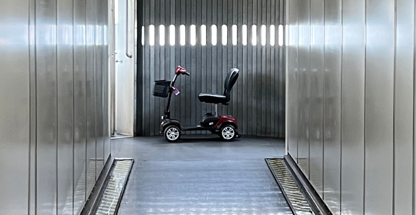 A scooter near an airplane loading door