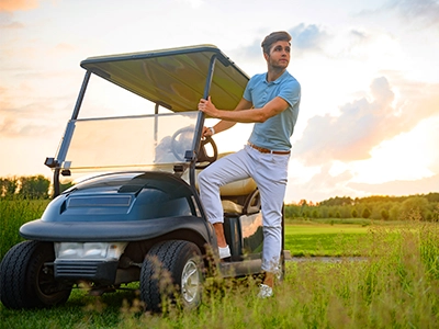 Person stepping into a golf cart