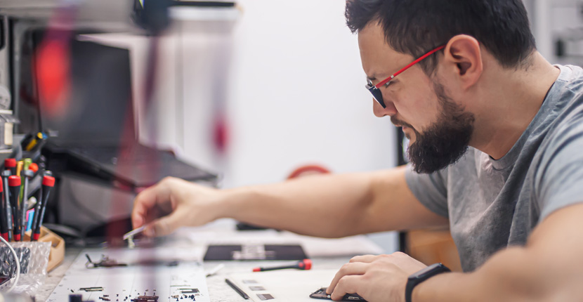 A repair tech working on a phone
