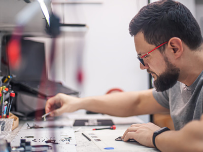 A repair tech working on a phone