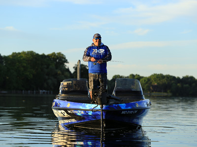 Fisherman on an X2Power wrapped boat wearing X2Power swag