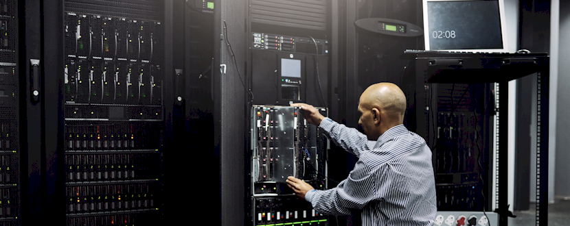 The man replacing a piece of a UPS for a company