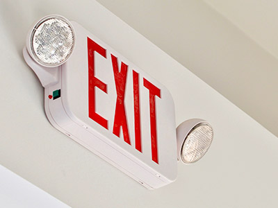 Emergency exit sign on business wall