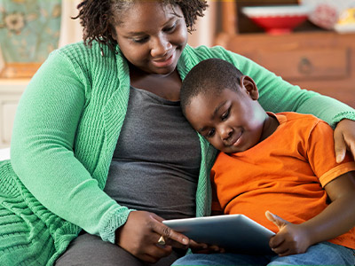 A mom and her son on a tablet together