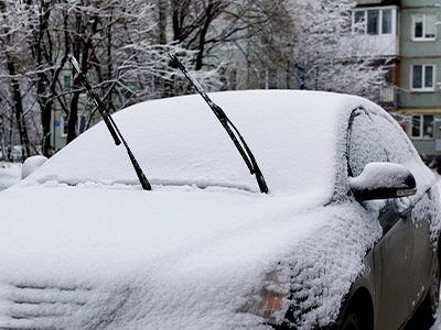 Car after a snow with the wipers up
