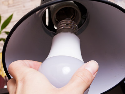 Screwing a LED light bulb into a lamp