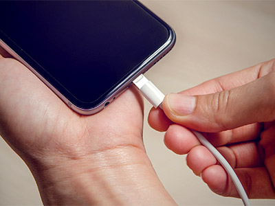 Phone being plugged into a charger
