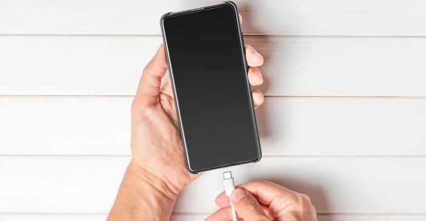 connecting a charger cord to a phone