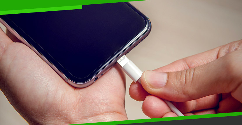 Phone being plugged into a charger