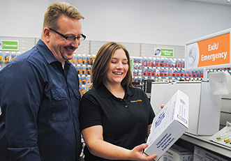 Store employee showing a customer a product